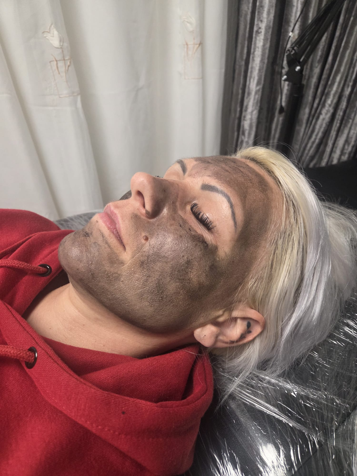 Carbon mask applied across a client's face at the start of a Carbon Facial